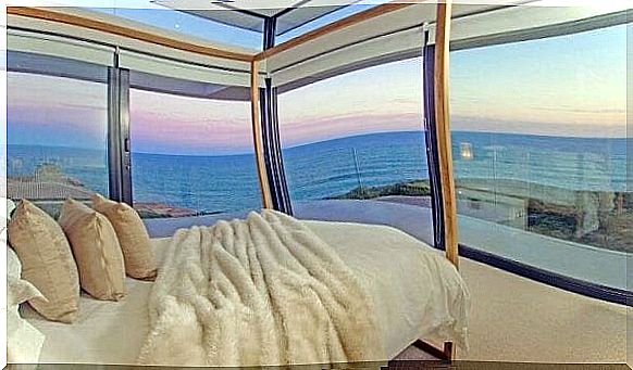 A luxurious room with glass walls on the beach