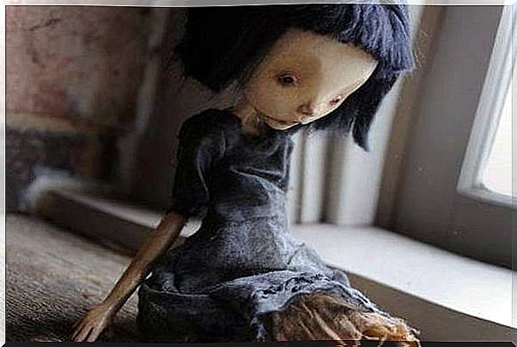 Sad doll marked by abuse