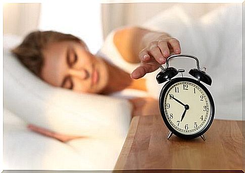 Woman turns off alarm clock