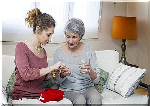 Care management: Daughter gives her elderly mother medicine