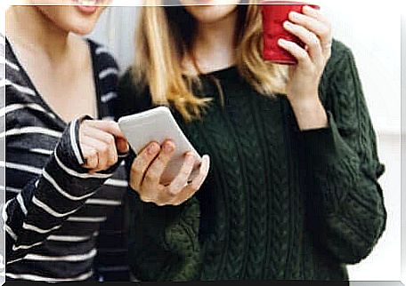 Two girls looking at a cell phone