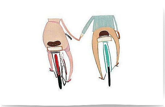 a couple of bikes, holding hands