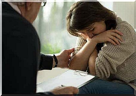 A woman crying while talking to a psychologist.