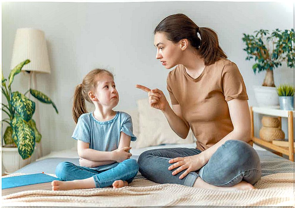 A woman lecturing a crying child.