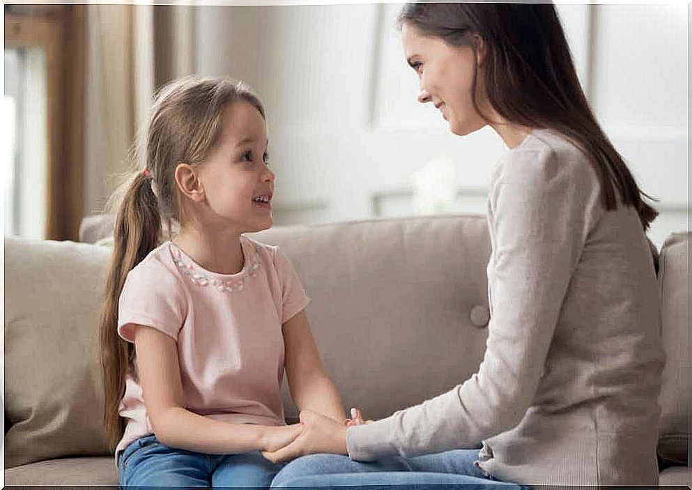 A child and a woman talking.