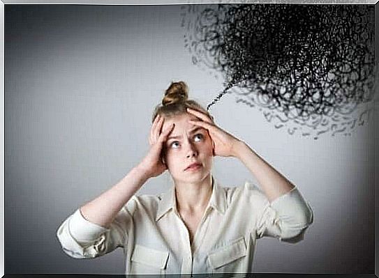 A woman holding her hands to her head, stressed by the black cloud of negative thoughts hanging over her.