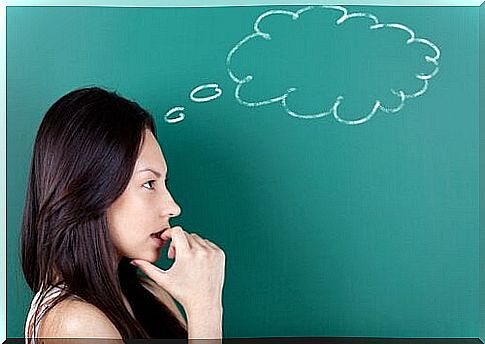 A woman in front of a blackboard